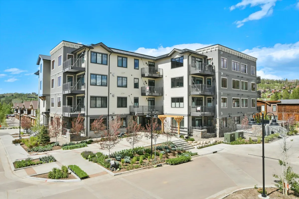 A welcoming exterior view of a modern apartment building surrounded by landscaped gardens and inviting pathways. The setting suggests opportunities for outdoor leisure, community gatherings, and easy access to neighborhood amenities.